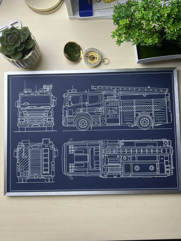 	Framed fire truck blueprint poster in silver metal frame on a desk, custom pen plotter wall art by Plotora