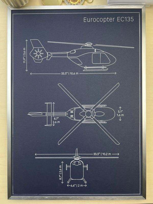 Framed Eurocopter EC135 helicopter blueprint showing side, top and front views, silver metal frame