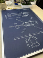 EC135 helicopter blueprint wall art in silver frame on a desk, custom pen plotter drawing by Plotora